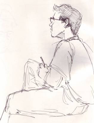 boy writing and looking up